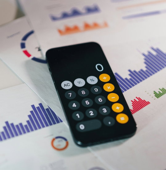 smartphone calculator app on financial report papers